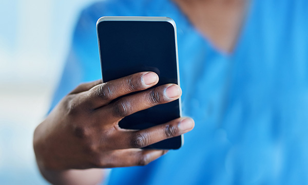 Nurse using mobile phone. Nurses were asked if they would share their unique nurse PIN on social media