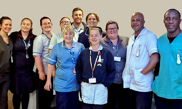Members of the Scarisbrick Inpatient Unit team, winners of the Mental Health Nursing award at the RCN Nursing Awards 2023, standing together in their workplace