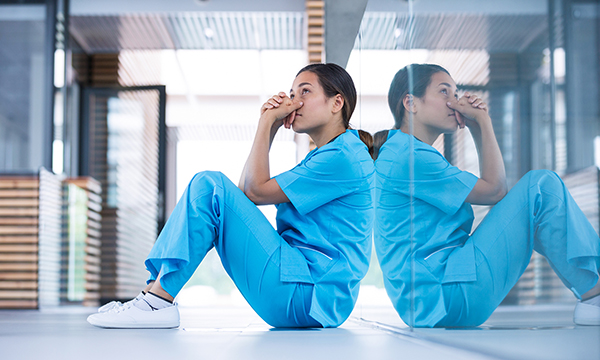 Ethical decision-making in practice: a nursing student sits on the floor in quiet contemplation