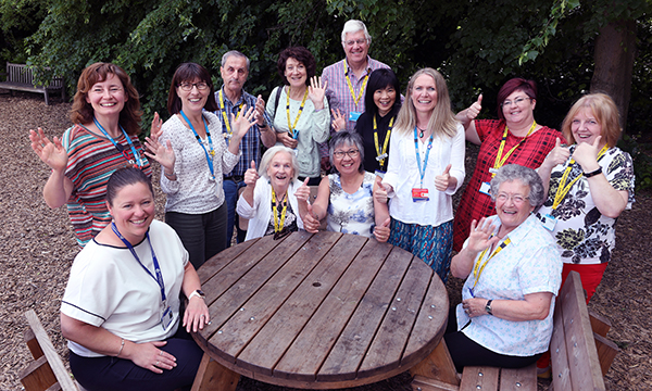 Commitment to Carers award winners Sally Kitchin (fourth from right) and Fe Franklin (seated, centre right) who set up the Dementia Carers' Support Service, with staff colleagues, carers and volunteers