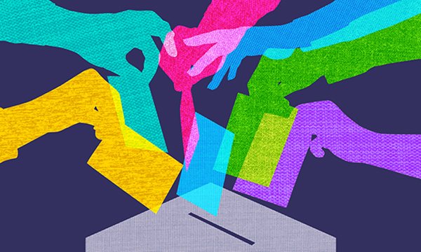 Hands putting papers into a ballot box