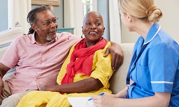Picture of a nurse caring for a patient at home