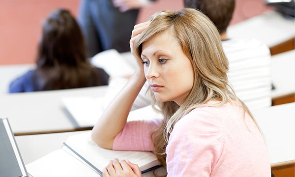 Professionalism in nursing: student looks bored and disengaged during a university lecture