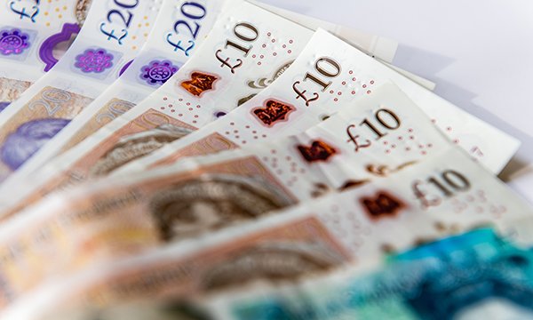 A group of £20 and £10 notes spread out on a surface
