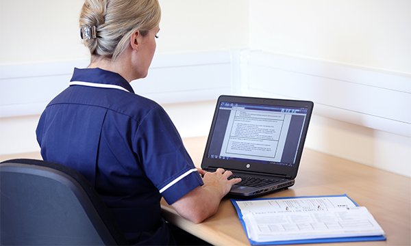 NMC revalidation: nurse completes electronic form, and refers to written document in a folder