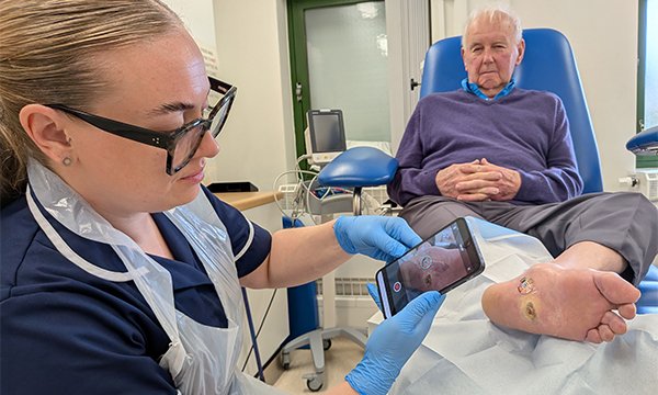District nurse deputy team leader Lauren Heald uses a smartphone to take a picture of a wound on a patient’s foot