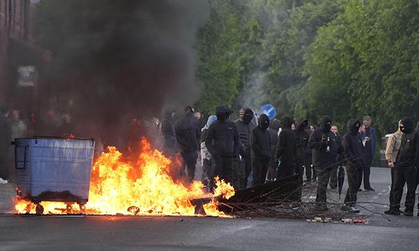 Bins set alight by protesters on Ligoniel Road, Belfast, as disorder flared during a demonstration organised in response to Monday night's stabbing attack in the city. Picture: Alamy