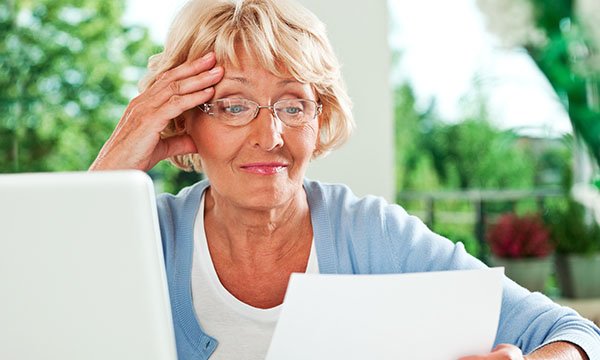 Picture shows an older woman reading a letter. The NMC has extended its appealing to those who have left in the past four or five years and those who trained overseas to join its COVID-19 temporary register.