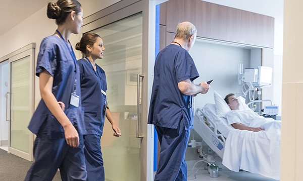 Nurses following a doctor into a hospital room with a patient. Picture: iStock