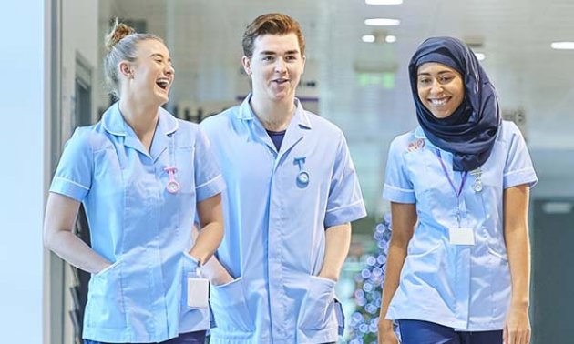 Three nursing students look happy to be on clinical placement together